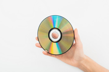partial view of man holding CD disc on white background