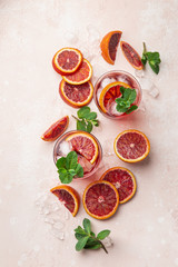 red blood orange cocktail with ice and fresh mint