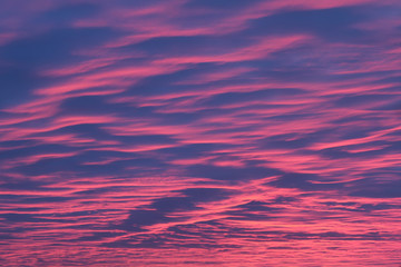 sky is blue and pink with clouds. sunset