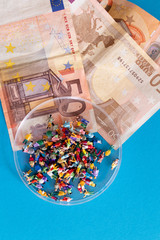 Money and people on petri dish. High price concept for population infection of pandemic coronavirus covid-19. Concept to describe spred of virus and cost for public health system.