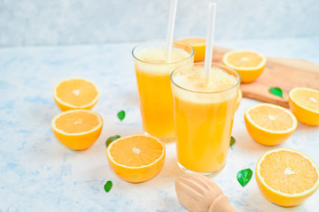 orange juice in a glass, top view, slices of oranges, straw, healthy lifestyle concept