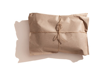 The parcel is wrapped with kraft paper and tied with a rope. Recyclable packaging material,...