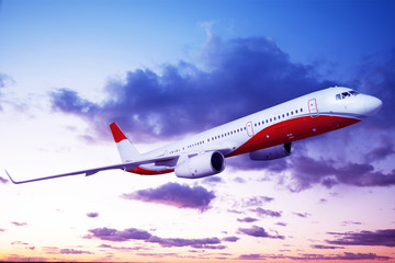 the plane is flying in the blue sky