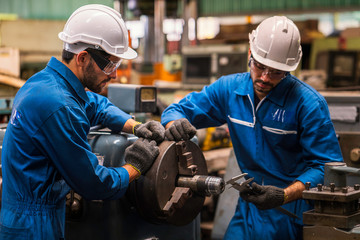 Professional technicians and engineers are working in industrial plants that work on steel.