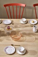 Illuminated interior with served table with colorful chairs
