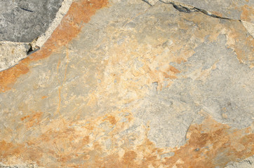 gray, orange wall of old house closeup. Light plaster with beige and brown stains. Cracks on the surface of building or fence. City building concept. Copy space. Place for text. Selective focus image.