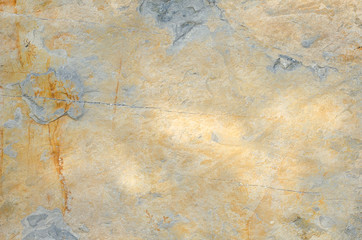 gray, orange wall of old house closeup. Light plaster with beige and brown stains. Cracks on the surface of building or fence. City building concept. Copy space. Place for text. Selective focus image.