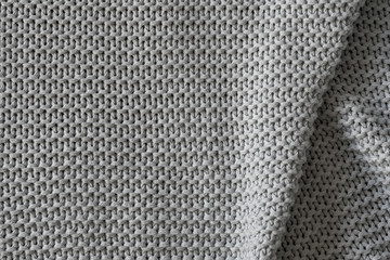 Texture of gray woolen fabric in macro shot of repeating elements