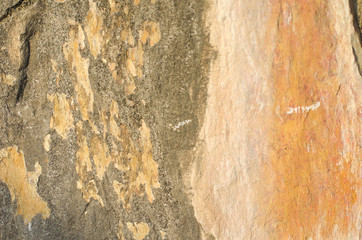 gray, orange wall of old house closeup. Light plaster with beige and brown stains. Cracks on the surface of building or fence. City building concept. Copy space. Place for text. Selective focus image.