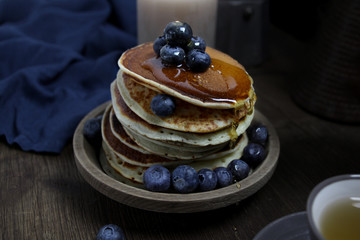 national dish pancakes, pancakes, pita with blueberries, linen napkin, poured with honey, the concept of traditional cuisine