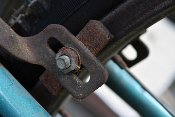 The old brake system of the bicycle is full of rust stains.