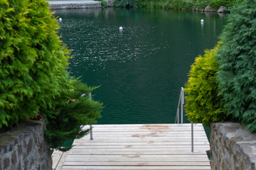 wooden springboard for descent to the mountain pool