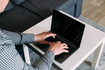 close up of hands working on computer at home