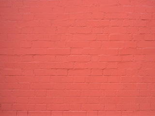 texture: old cracked brick wall painted in red paint