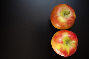 Apples on black table, food background