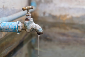 Water from old bass faucet connect to the blue pvc pipe flowing into water surface of bath made of...