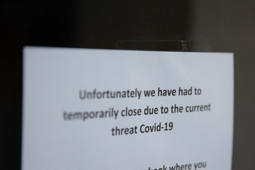 Retail shops and businesses display closed signs due to the coronavirus outbreak
