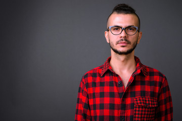 Fototapeta premium Face of handsome bearded Turkish hipster man with eyeglasses