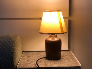 lamp on table with sleeping bed in bedroom