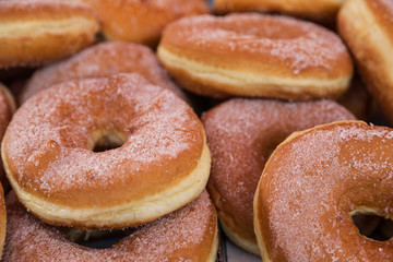 cakes in the form of rings with filling sprinkled with sugar crumbs on the shop window