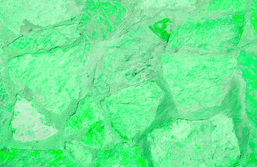 Fragment of old house wall close-up. Green background. Peeling plaster on concrete surface. Cracks in paint. Copy space. Place for text. Selective focus image.