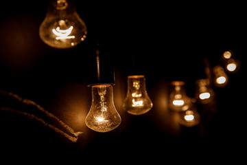 A row of light bulbs. Focus on the closest.