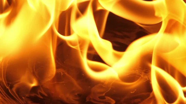 Slow motion speed close up scene on burning matchstick dropping on grunge floor that soak with oil, fast spread of blue hot flame above fuel surface, blasting fire stream pattern ignite on petroleum