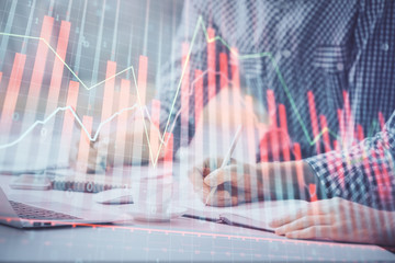 Multi exposure of forex chart with man working on computer on background. Concept of market analysis.