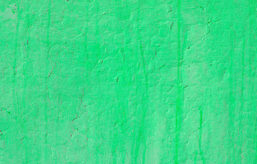 Fragment of old house wall close-up. Green background. Peeling plaster on concrete surface. tinted green. Cracks in paint. Copy space. Place for text. Selective focus image.