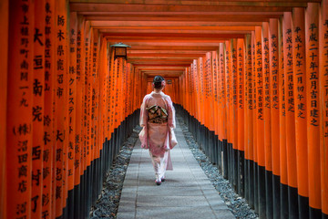 Red Torii Arches with Kimono in Kyoto Japan