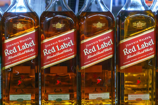 Tyumen, Russia-March 06, 2020: Johnnie Walker whisky red label bottle on the shelves of hypermarkets