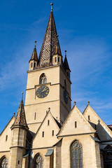 Fototapeta na wymiar Church tower against blue sky