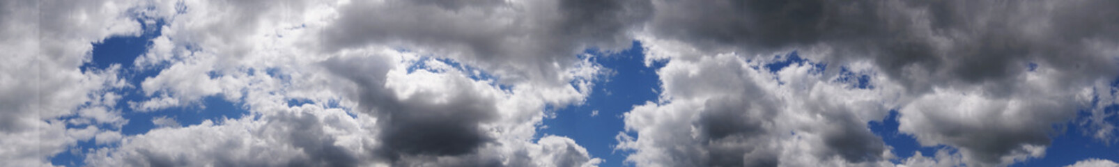 Fototapeta premium White fluffy soft clouds on a blue saturated sky on a sunny summer day