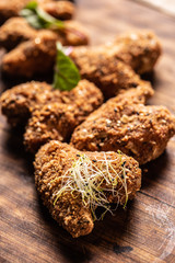 Fried chicken wings on wooden butcher board