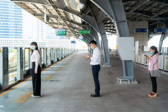 Three Asian people wearing mask standing distance of 1 meter from other people keep distance protect from COVID-19 viruses and people social distancing  for infection risk