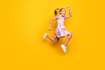 Fototapeta na wymiar Full size profile side photo of cheerful funky crazy kid jump run hurry black friday bargain wear ponytails pigtails shoes plaid skirt isolated shine yellow color background