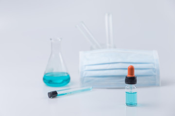 Flask,test tubes,dropper,mask with lab glassware  in chemical and science laboratory , medical tools.  Research and development concept.