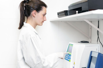 Female doctor in the laboratory with a blood tube for analysis and sampling of Coronavirus .