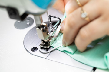 Experienced seamstress sews fabric protective masks as standard during the COVID-19 epidemic.