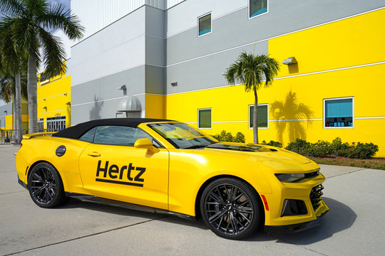 ESTERO, FL -30 JAN 2020- View of a yellow Hertz rental car in front of the Hertz Arena, a multipurpose arena located in Estero, Florida, United States, near Fort Myers.