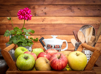 Group of fresh apples ready to be sold. Wooden basket and rustic background. Farmer's harvest