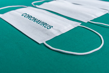 Surgical mask over minimalist green background