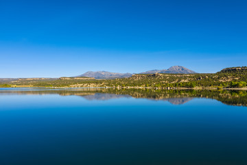 Fototapeta na wymiar Panorama view of landscape american nature. Blue sky and lake, mountains reflection in water. Recapture reservoir in Utah state, USA country