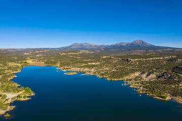 Aerial view of landscape american nature. Blue sky and lake,  mountains reflection in water. Recapture reservoir. Utah state, USA