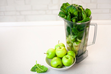 green set of products for a healthy smoothie was put in a blender: lemon, apple, avocado, spinach. Morning detox for a healthy lifestyle, weight loss, ketone diet, raw food diet