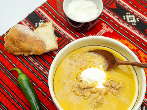 traditional romanian dish tripe soup known as ciorba de burta served with cream and pepper