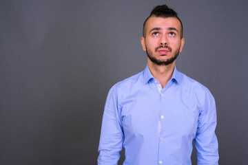 Fototapeta premium Portrait of handsome bearded Turkish businessman rolling eyes