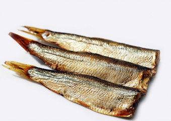 Hot smoked sprats or in oil on a white background. Small salted fish.