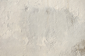 gray wall of old house closeup. White peeling plaster. Cracks on the surface of building or fence. City building concept. Copy space. Place for text. Selective focus image.