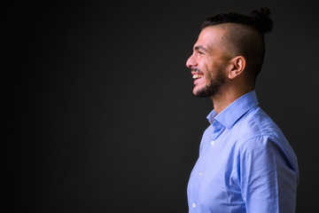 Obraz premium Closeup profile view of happy bearded Turkish businessman smiling